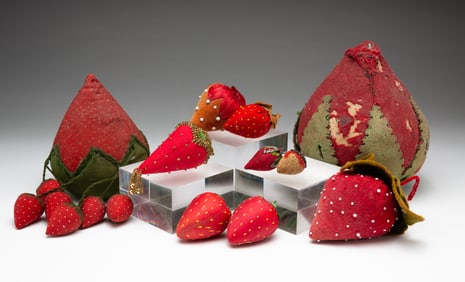TEN STRAWBERRY PINCUSHIONS.