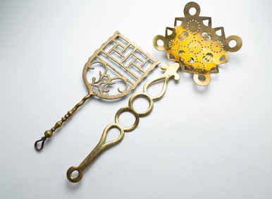 TWO BRASS UTENSILS.