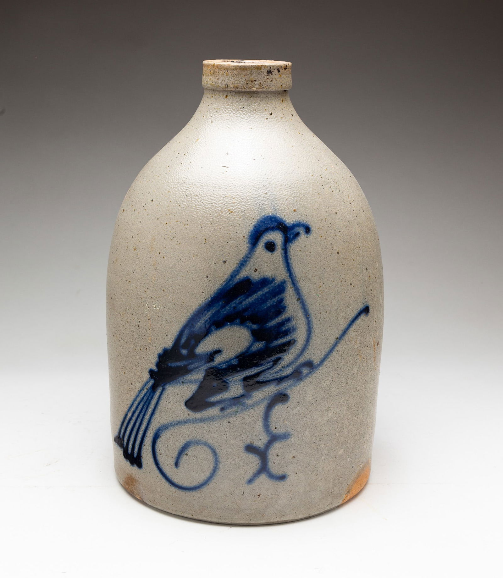 STONEWARE JUG WITH COBALT DECORATION.: American, 19th Century. Applied handle with peafowl cobalt decoration. 11"h.