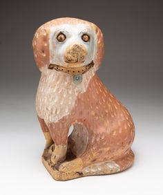 BUFF CLAY MOLDED SPANIEL WITH PAINTED FEATURES.