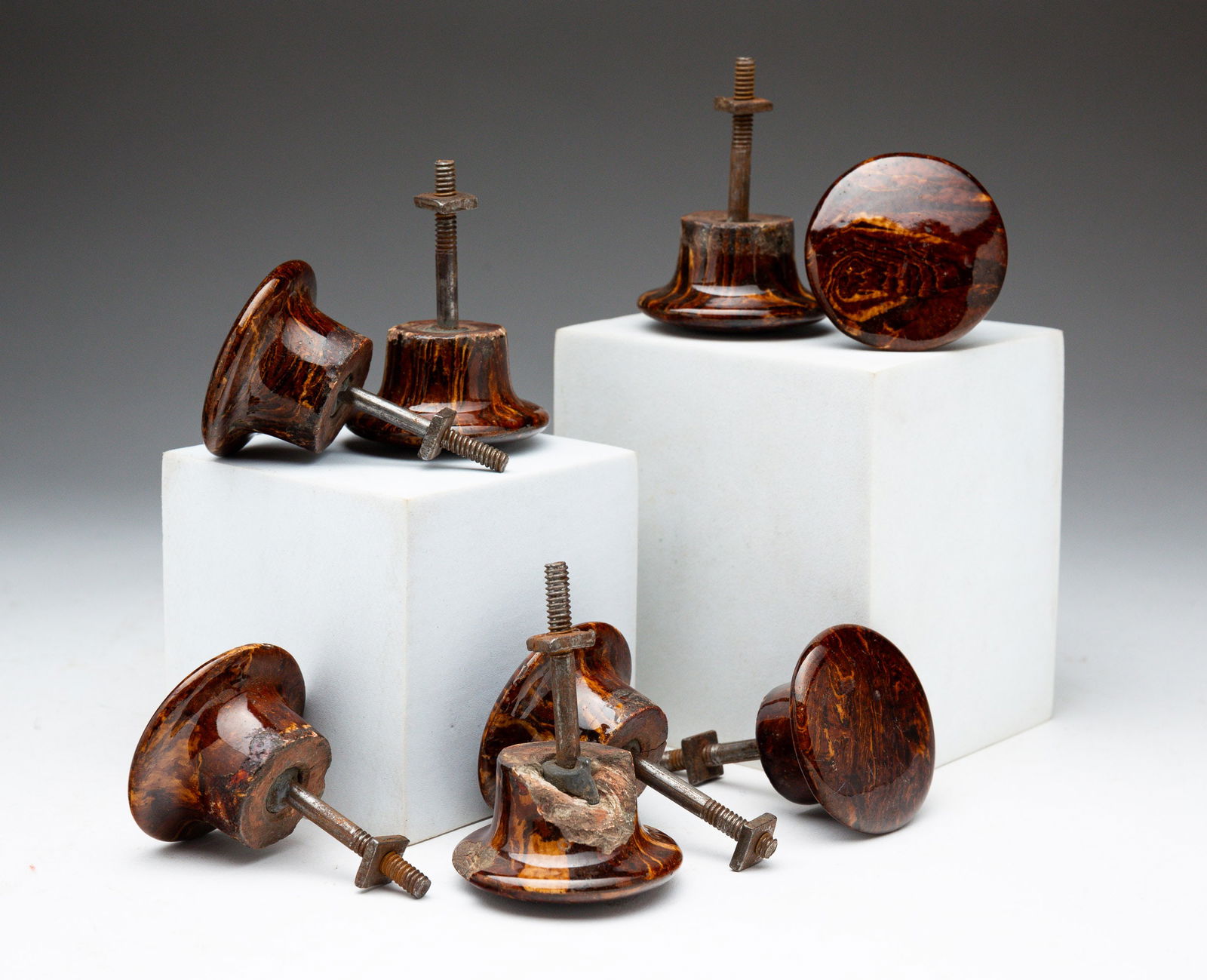 GROUP OF EIGHT BENNINGTON-GLAZED DOOR KNOBS.: American, 19th Century. Classic marbled brown and yellow pattern. All threaded posts retain square screw nuts.