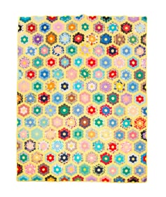 PIECED HONEYCOMB PATTERN QUILT.