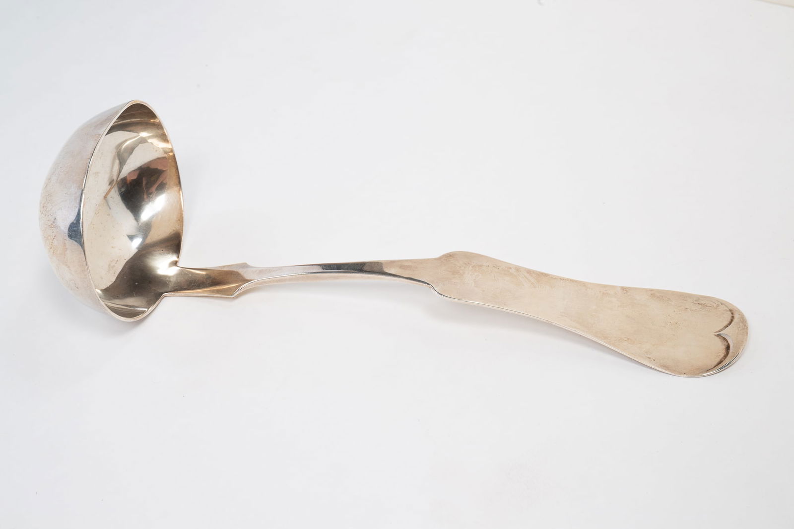 CINCINNATI COIN SILVER LADLE SIGNED DUHME & CO.: American (Cincinnati, Ohio), circa 1880. Oversized fiddleback handle with nicelt shaped bowl. Marked "Duhme & Co.".13.5"l. Approximately 9.5 ozt. From the collection of Mark and Sandy Keily.