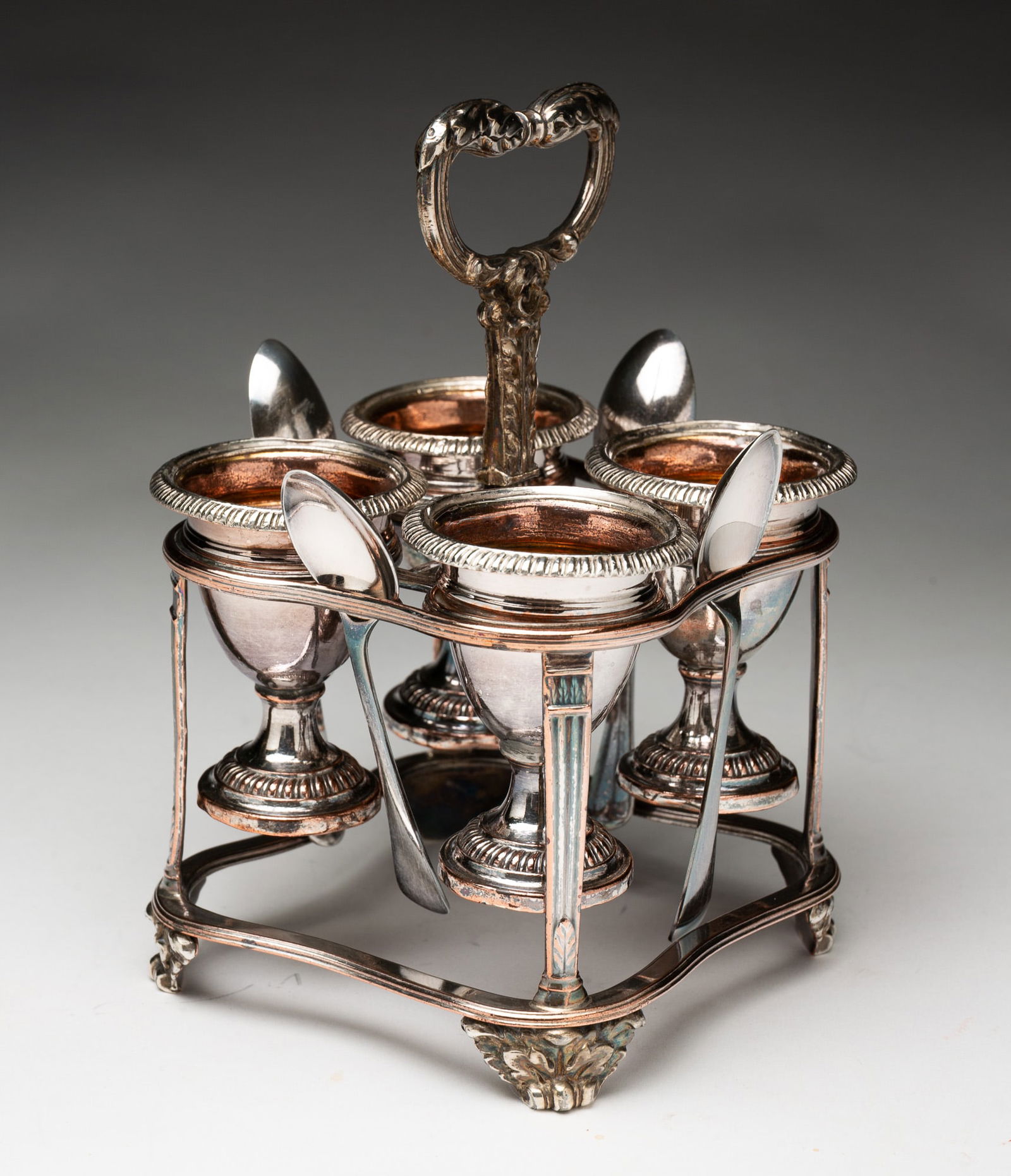 GEORGE III ENGLISH SHEFFIELD SILVER PLATE EGG CRUET BY MATTHEW BOULTON (1728-1809).: England (Birmingham), 18th / 19th Century. Hallmarks with maker's old Sheffield plate twin sun mark. Scarce form egg cruet with four gadrooned and gilt-washed pedestal egg cups held in a heavy cast fr