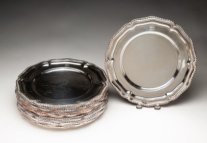 SET OF SIXTEEN GEORGIAN-STYLE ENGLISH SILVER PLATED LOBED CHARGERS.
