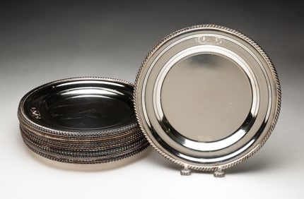 SET OF SIXTEEN ENGLISH SILVER PLATED DESSERT PLATES WITH GADROONED RIMS.