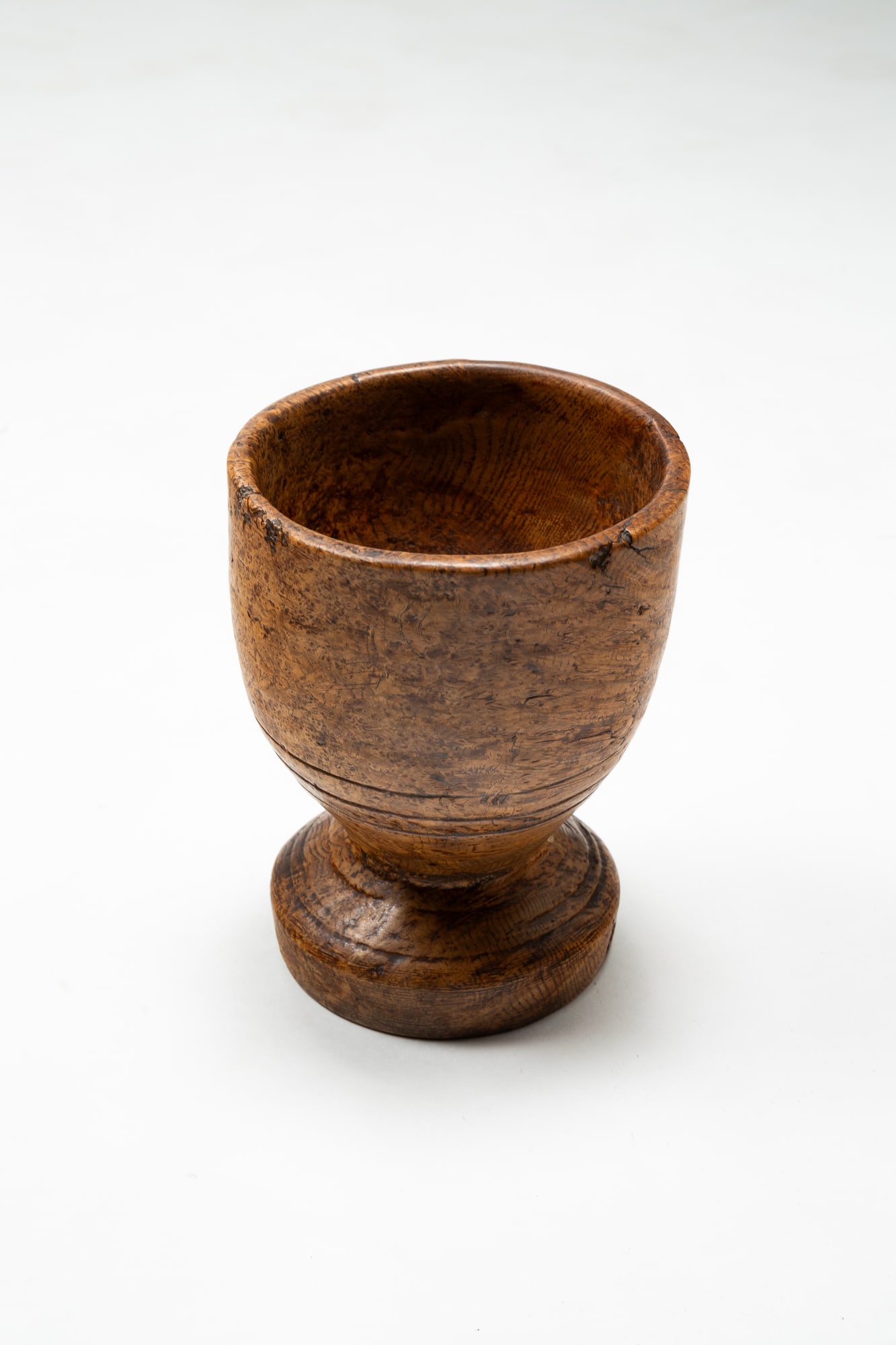 TREEN FOOTED PESTLE.: American, 19th Century. Nice shape with incised circles on foot and bottom of bowl. 7.5"h. 5.75"w. Sold at Garth's July 10, 1999, Mrs. Jean Stuck-Monger Collection.