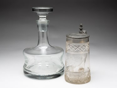 WONDERFULLY ENGRAVED DECANTER AND TANKARD.