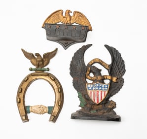 THREE CAST IRON ITEMS WITH EAGLES.