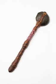 AMERICAN INDIAN STONE CLUB WITH BEADED DECORATION.