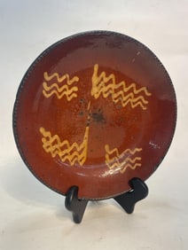 SLIP DECORATED REDWARE CHARGER.