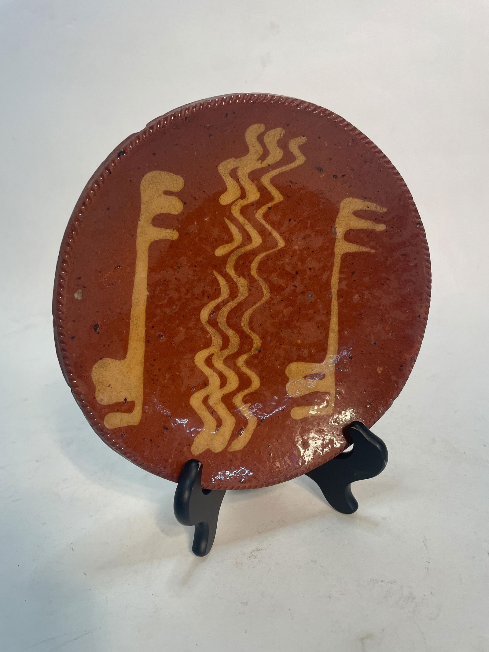 SLIP DECORATED REDWARE PLATE. (1 of 3)