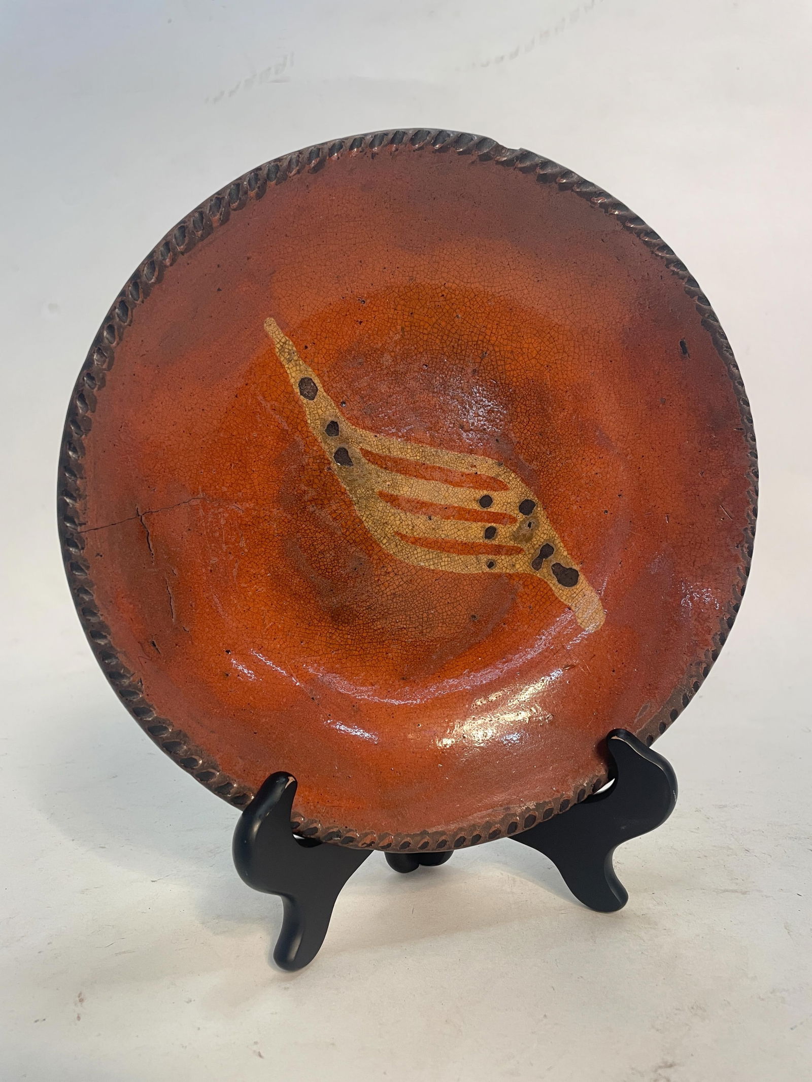 SLIP DECORATED REDWARE PLATE. (1 of 3)