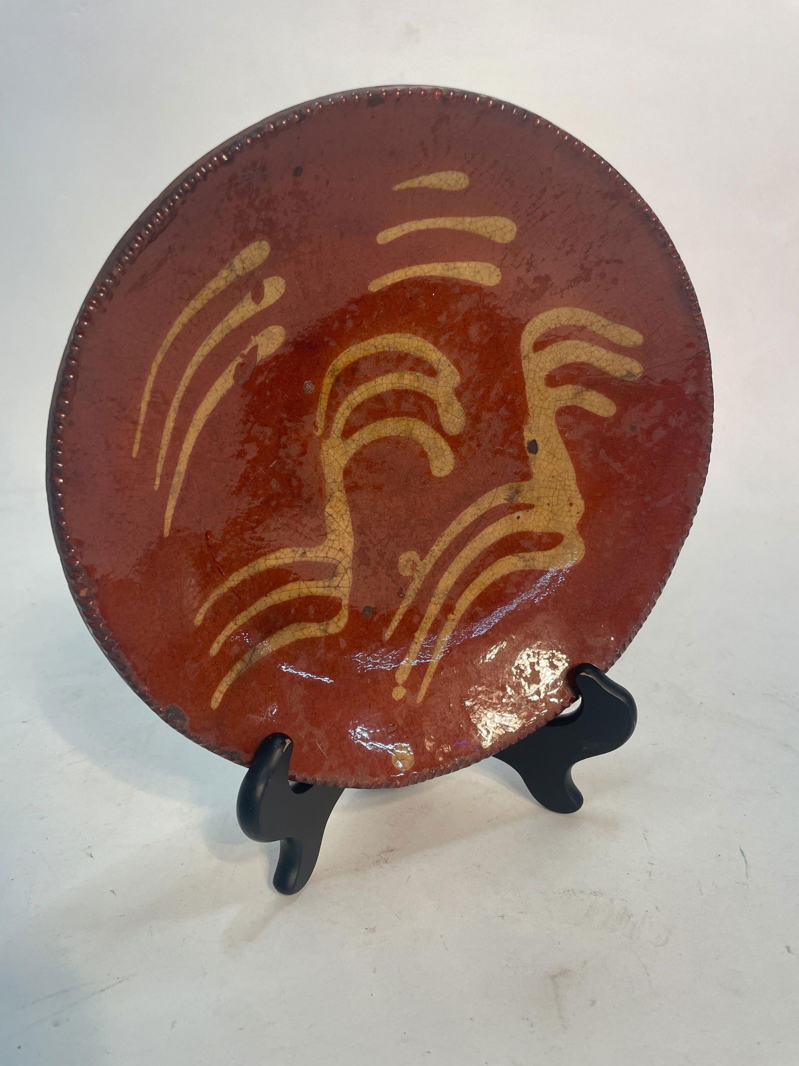 SLIP DECORATED REDWARE PLATE. (1 of 4)