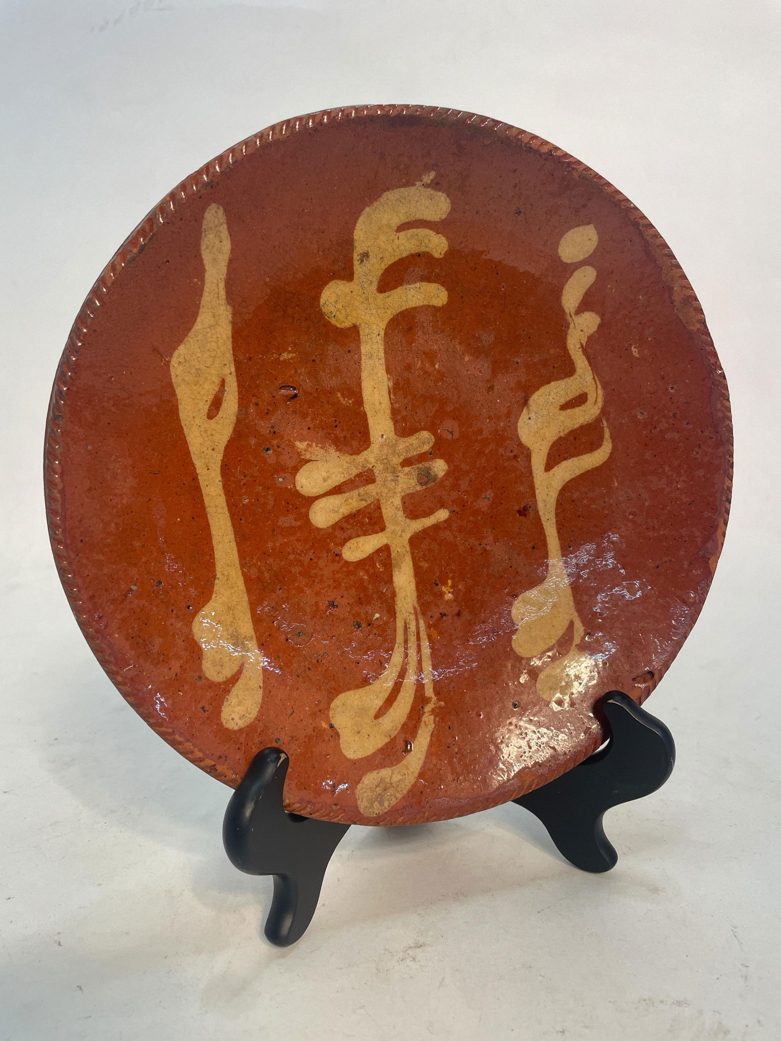SLIP DECORATED REDWARE PLATE. (1 of 3)