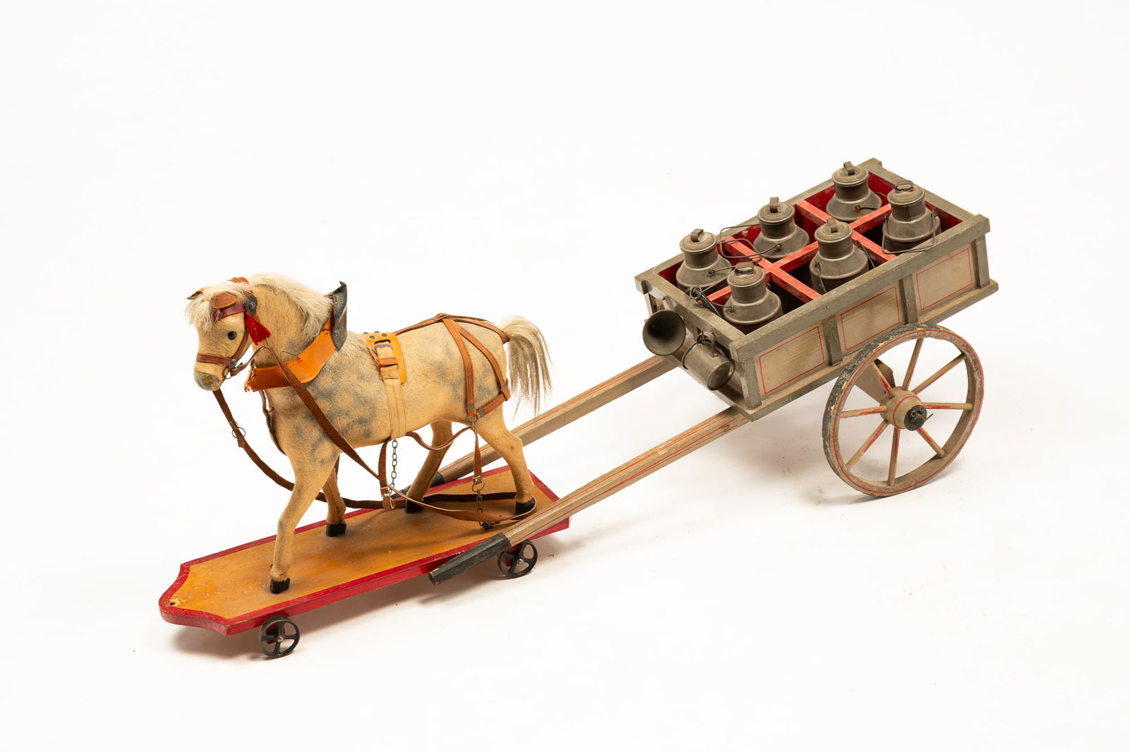 HORSE DRAWN MILK WAGON CHILD'S TOY.: American (possibly Maryland), circa 1900. Dappled horse on a base with red trim and cast iron wheels pulling a two wheel cart with light and dark gray paint and red striping caring six tin milk cans.