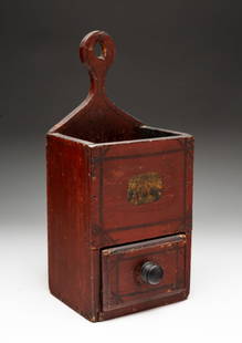 PENNSYLVANIA PAINT-DECORATED PINE HANGING PIPE BOX.: American (Pennsylvania), 19th Century. Pine. Lollipop shaped back, solid sides and front with painted castle. Lower drawer with square nail construction. In old red paint. 13"h. 6"w. 4.5"d.