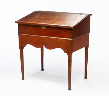 AMERICAN QUEEN ANNE RED-WASHED PINE CLERK'S DESK-ON-FRAME.: American, 18th Century. Pine. Hinged slanted writing surface, dovetailed case and interior well with shelf. Base with scalloped front apron, turned tapered legs, pegged construction and the whole