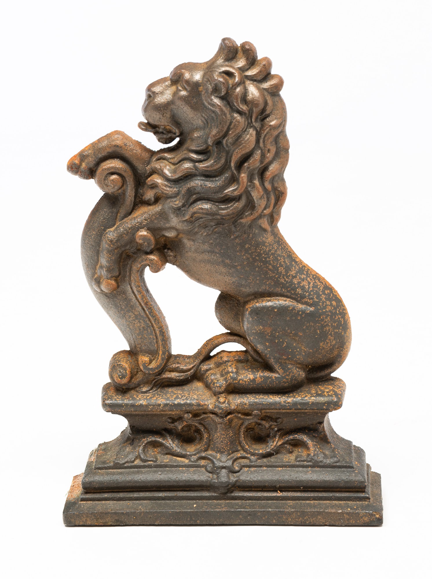 ENGLISH CAST IRON RAMPANT LION DOORSTOP.: English, Late 19th Century. Rampant form resting on a bracket on elaborate plinth. 14.5"h.10"w. 2.5"d.