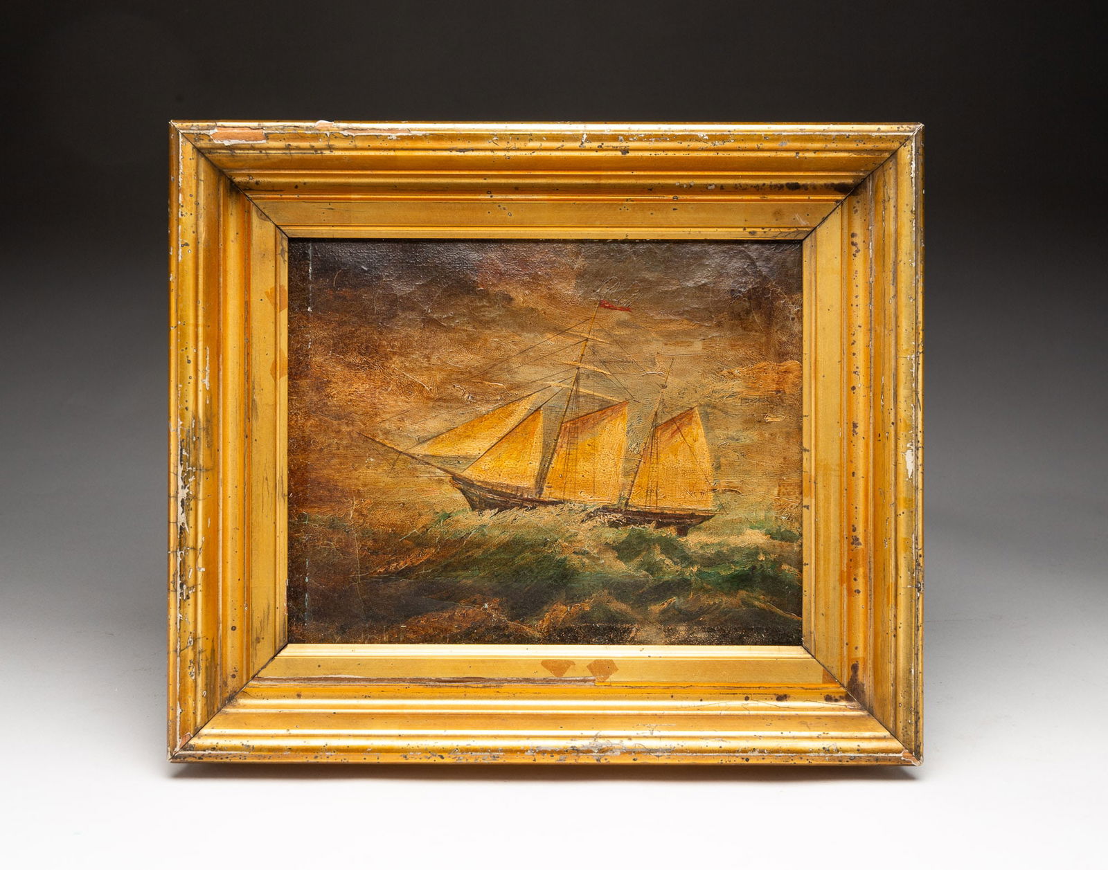 AMERICAN SCHOOL OIL ON CANVAS OF STORMY SEASCAPE WITH SCHOONER.: American, 19th Century. Oil on canvas. A two-masted schooner under full sail in very rough seas. 8"h. 10"w. Period giltwood frame, 10.75"h. 12.75"w.