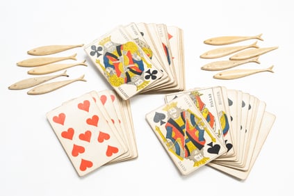 DECK OF FRENCH PLAYING CARDS PLUS CARVED BONE FISH GAMING COUNTERS.