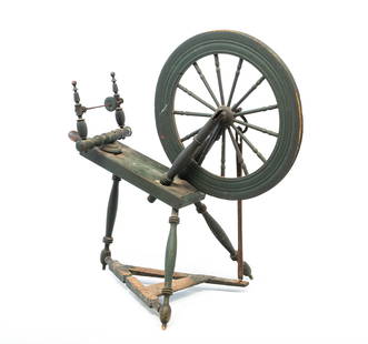AMERICAN DARK GREEN-PAINTED SPINNING WHEEL.: American, 19th Century. Nice turnings and blacksmith made fittings. Nice dark green painted surface. 37.5"h. 22.5"w. 36"d. Ex Colette Donovan (Massachusetts).