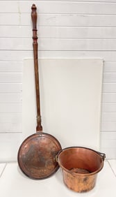 A COPPER BAIL-HANDLED PAIL AND PEAFOWL-DECORATED BED WARMER.