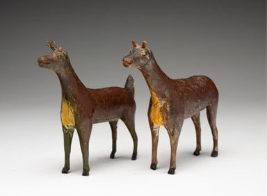 TWO AMERICAN FOLK ART CARVED AND PAINTED WOOD DEER.