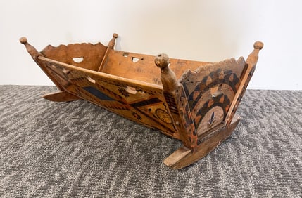 SCANDINAVIAN CARVED AND POLYCHROMED PINE BABY CRADLE.