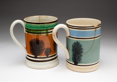 TWO ENGLISH MOCHAWARE SEAWEED DECORATED TANKARDS.
