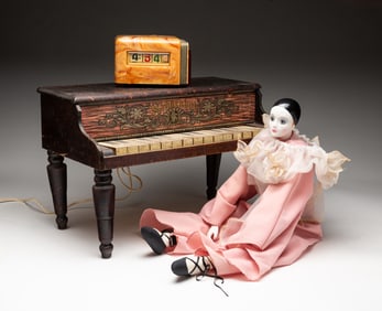 A TOY SCHOENHUT PIANO, AN ART DECO STYLE CLOCK, AND A PIERROT DOLL.