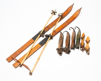PAIR OF WOOD SKIS WITH POLES AND THREE PAIRS OF ICE SKATES.