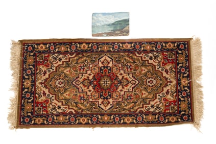 A SMALL SEASCAPE AND A MACHINE MADE AREA RUG.