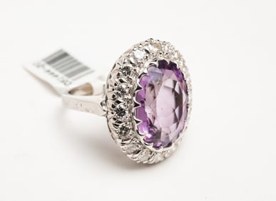 14K AMETHYST AND DIAMOND HALO RING.