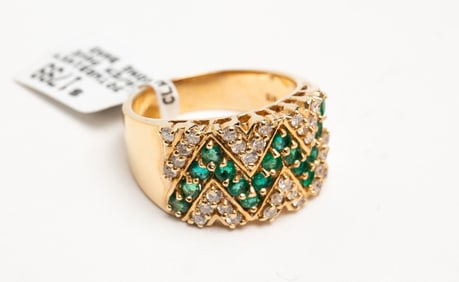 YELLOW GOLD BAND PAVE SET WITH DIAMONDS AND EMERALDS.