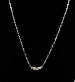 FIVE-STONE PRINCESS CUT DIAMOND NECKLACE.