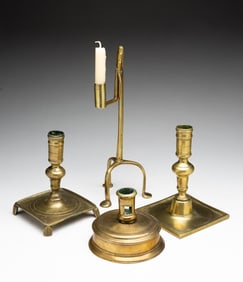 FOUR EUROPEAN BRASS CANDLE HOLDERS.