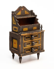 AMERICAN FOLK ART CARVED AND PAINTED PINE THREE-DRAWER MINIATURE CHEST.