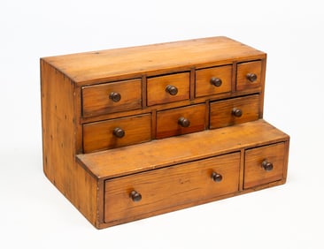 SOUTHERN YELLOW PINE NINE-DRAWER STEPBACK APOTHECARY.