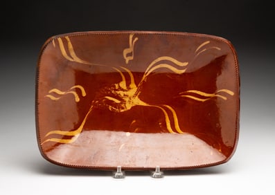 AMERICAN SLIP-DECORATED REDWARE LOAF PAN.