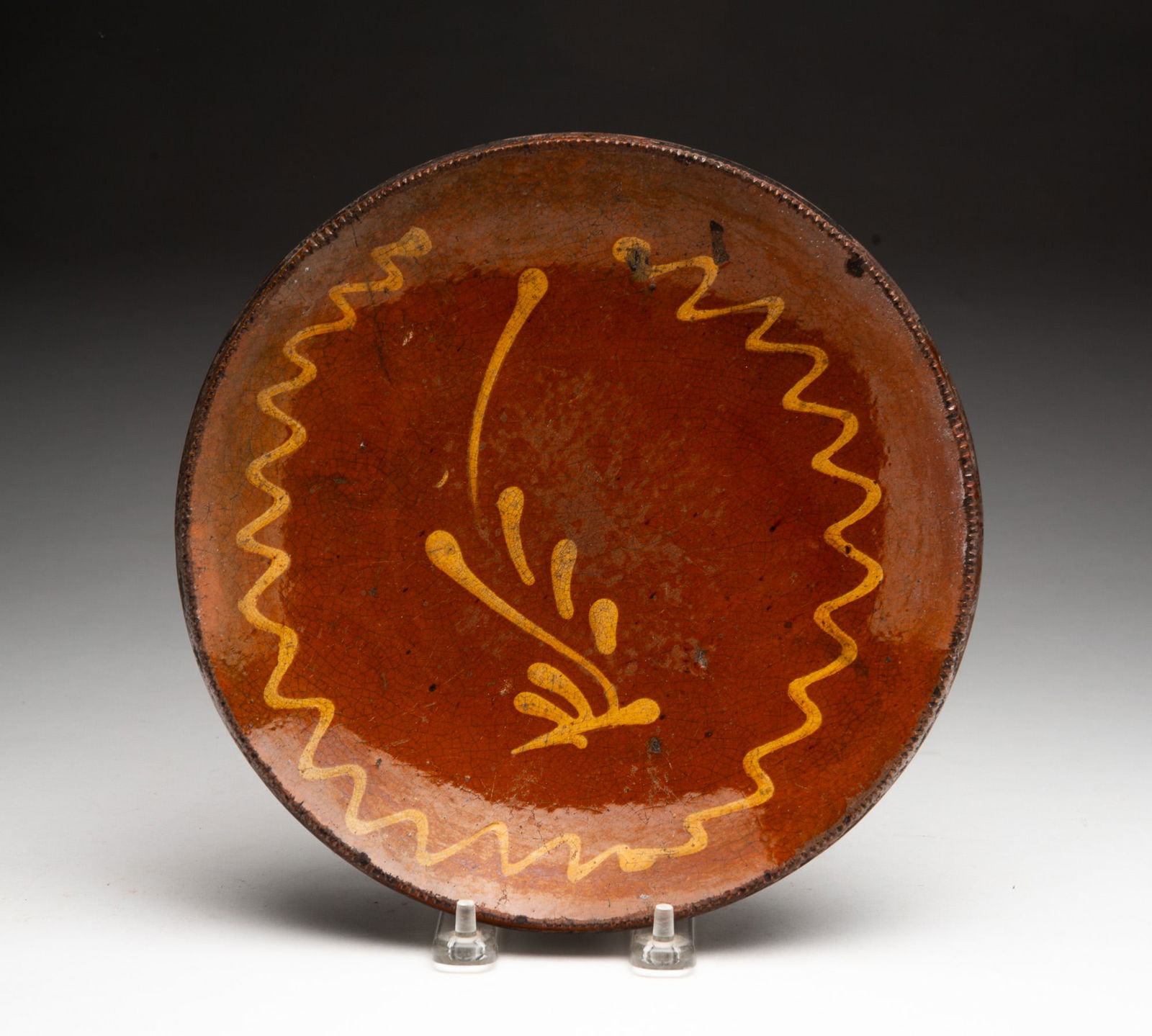 PENNSYLVANIA SLIP-DECORATED REDWARE PLATE. (1 of 2)