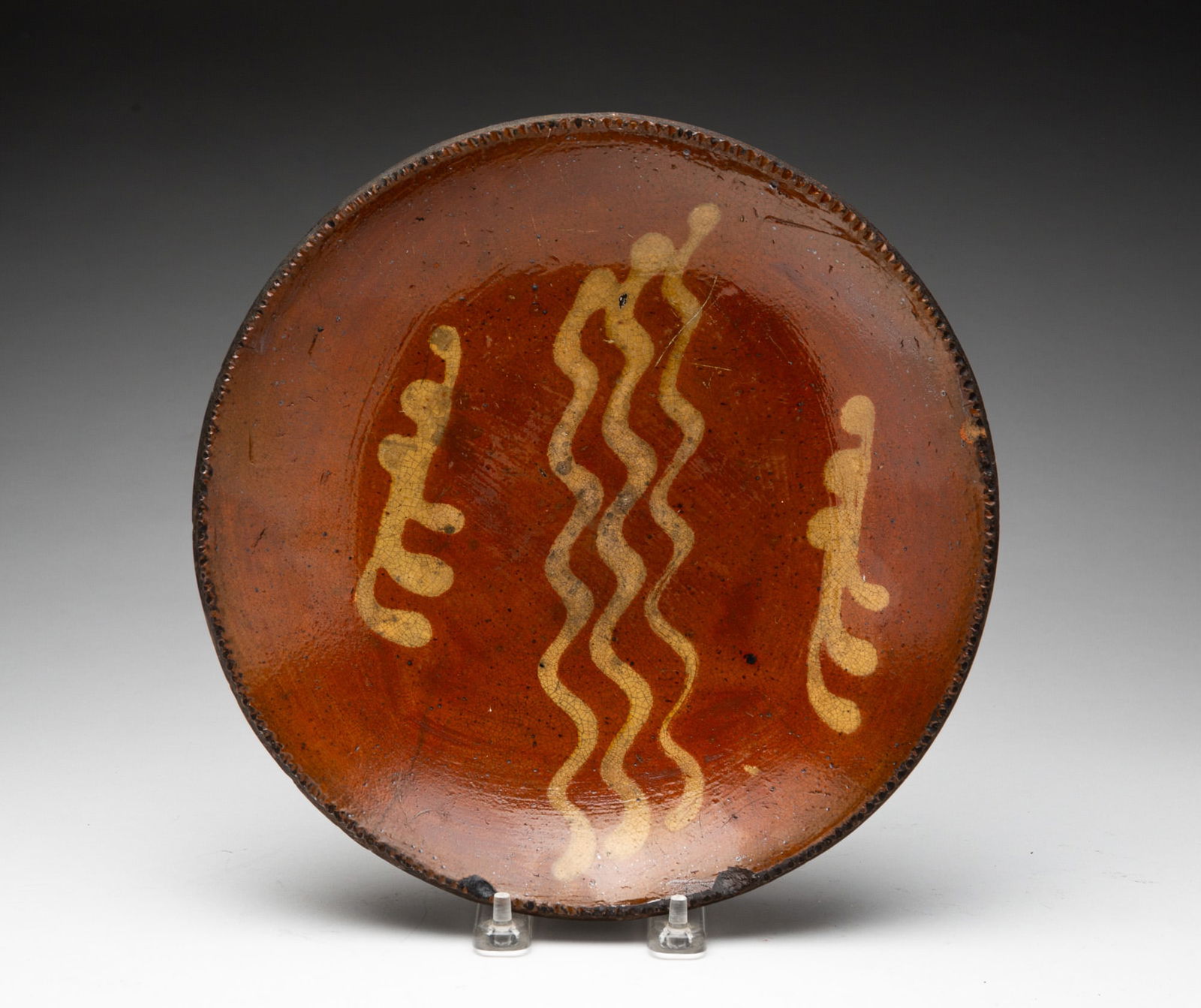 AMERICAN SLIP-DECORATED REDWARE PLATE. (1 of 3)