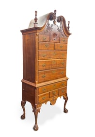ANTIQUITY CHIPPENDALE STYLE CLARO CIRCASSIAN WALNUT BONNET TOP HIGH CHEST IN THE PHILADELPHIA STYLE.