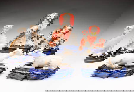SIX STAFFORDSHIRE DOG FIGURINES.: England, 19th Century. A Blenheim spaniel and a black eared pup on cobalt blue base, 6"h. Blenheim spaniel with basket of flowers and two pups on a cobalt blue inkwell base, 4.75"h. A pair of seated w