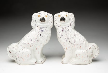 PAIR OF STAFFORDSHIRE SEATED SPANIELS.