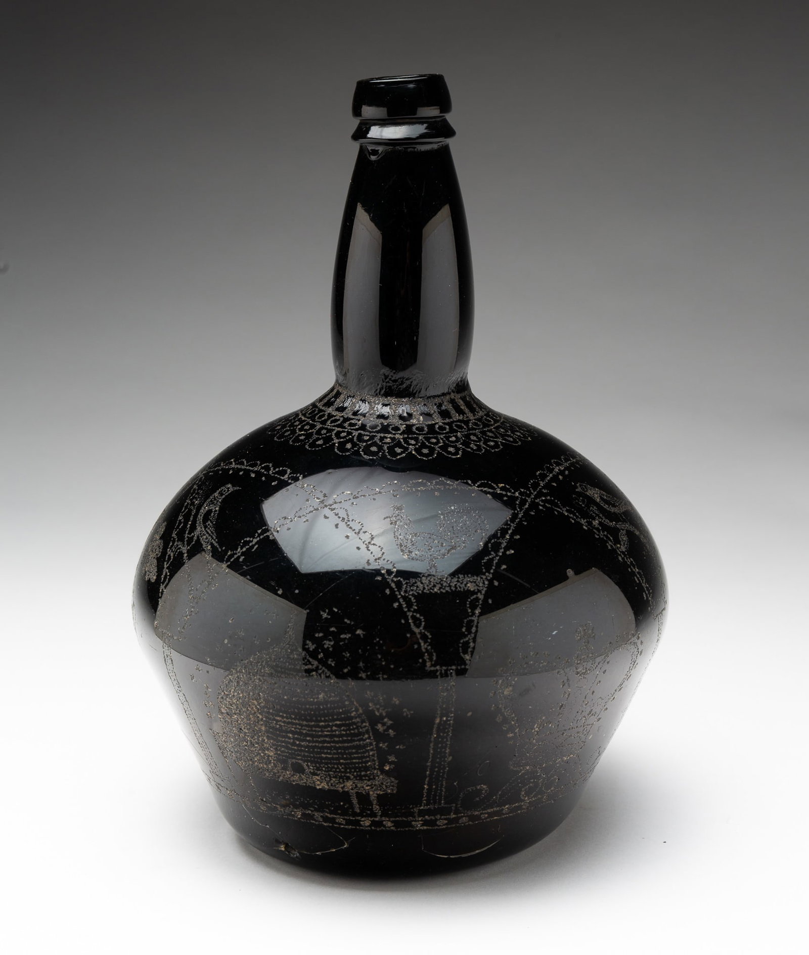 ENGLISH STIPPLE-DECORATED OLIVE GLASS “WEDDING BOTTLE", DATED 1850.: English, dated 1850. Olive green glass with iron pontil inscribed "JAMES AND JEAN COCHRINE 1850'' with stippled birds, butterflies, grapes, beehive, pot of flowers, crown, and lace-like trim. 10.5"h.