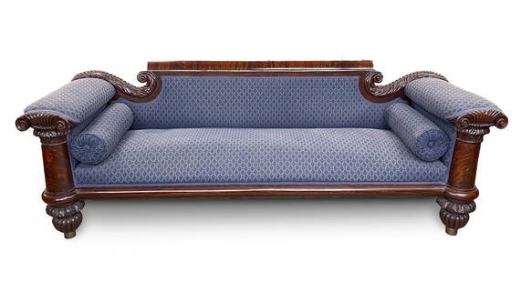 AMERICAN CLASSICAL MAHOGANY AND CUSTOM-UPHOLSTERED SOFA.: American, Second quarter 19th Century. Mahogany and mahogany veneer. Rolled back rest flanked by scrolled carved plumes, arm front columns with carved composite capitals, rounded seat rail, foliate ca