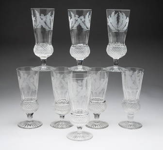 EIGHT EDINBURGH CRYSTAL "THISTLE" CHAMPAGNE FLUTES.: Scotland, 20th Century. Cut crystal flutes with a flared top rim above an etched thistle design. One is marked. 6.75"h. 2.5"d. From the Collection of Tom and Lenore Karras (Geneva, Illinois).