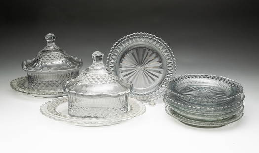 SIX CUT GLASS UNDERPLATES AND TWO CUT GLASS BUTTER TUBS WITH UNDERPLATES.: England or Ireland, 19th Century. Butter plates of round form with scalloped edges, 6.75"d. Butter tubs of oval form with lids and having oval form underplates, with scalloped edges. 7"h. 9.25"w.