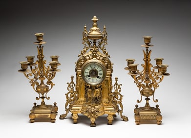 JAPY FRÈRES GILT BRASS MANTLE CLOCK AND GARNITURES.